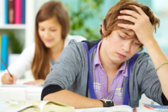 Tired student studying at library